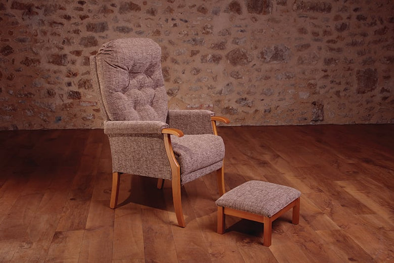 Image of the Avon Kilburn Cocoa Fireside Chair with a matching stool in an empty room.