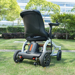 User riding the Robooter E30 powerchair on a park path, showing outdoor capability